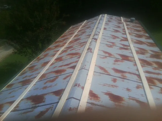 Rusted metal roof panels with new wood purlins before replacement — Storm Damage Roof Repair in Braintree by Roofing Brothers
